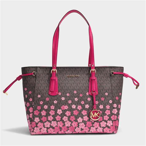 michael kors purses tan with flowers on it|Michael Kors hand luggage.